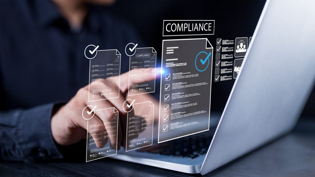 Image showing businessman monitoring a federal subcontractor checklist on a laptop.
